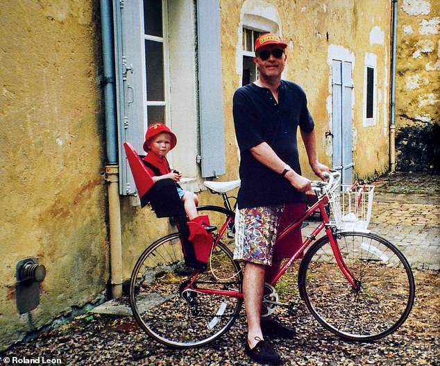 Jonathan as a baby pictured sitting in a baby carrier attached to the back of his father's bike