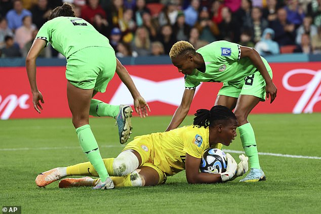 Then, minutes later, Chiamaka Nnadozie makes another stave, stopping Daly's effort at goal before collecting the ball on the ground (pictured)