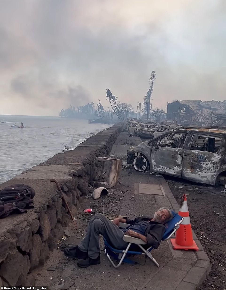 A man sits in a chair amid the total destruction of the island. Joe Biden called for Federal aid to reach Hawaii on Wednesday evening