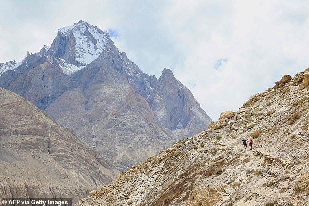 K2 - pictured from overlooking town Askole in the Gilgit¿Baltistan region of Pakistan - gained notoriety as the 'Savage Mountain' after American mountaineer George Bell descended from the peak in 1953