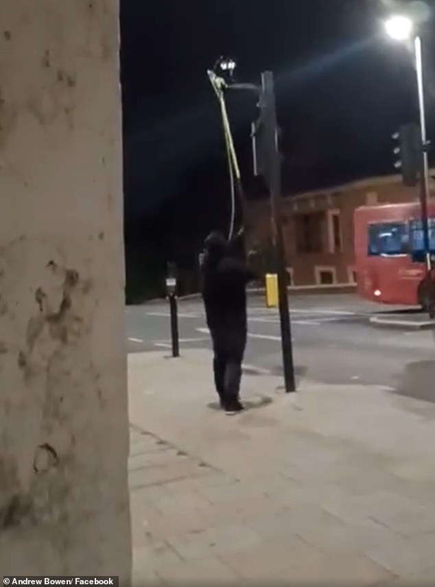 The activist from the covert group then casually walks to another ULEZ camera nearby and uses the gardening tool to snip the cable