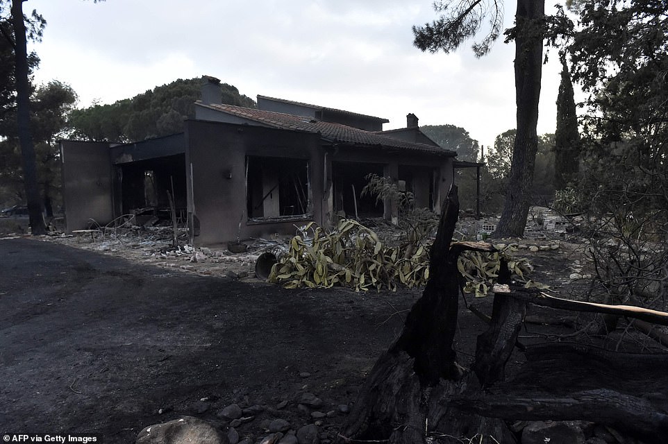 The smouldering remains of a house are seen in the aftermath of the fire that ravaged Saint Andre on Tuesday