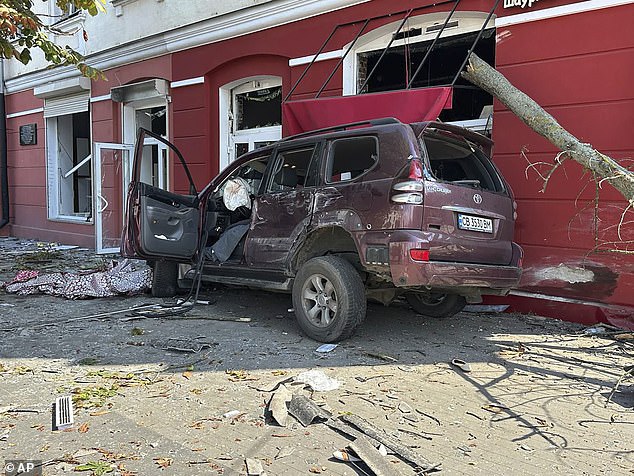 A car is seen smashed up and damaged after Russia's strike on the northern Ukrainian city