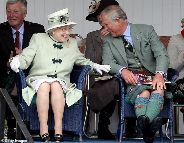 The late Queen Elizabeth II is pictured at the Braemar Highland Games in September 2010 alongside her son, then Prince Charles, Prince of Wales