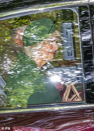 With a taupe coloured handbag on her lap, Queen Camilla smiled at well-wishers as the couple drove through the rural roads around Balmoral