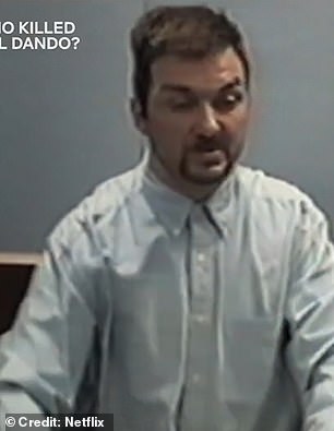 Being questioned by detectives over the image of him in the gas mask