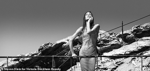 Incredible: In another sizzling snap, Victoria donned a stunning sheer gown while posing by the beach