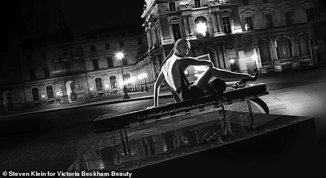 Gorgeous: Victoria donned a black silk mini-dress before posing in the streets of the City of Light