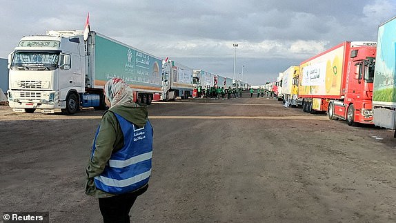 FILE PHOTO: Trucks carrying humanitarian aid from Egyptian NGOs for Palestinians, wait for the reopening of the Rafah crossing at the Egyptian side, to enter Gaza, amid the ongoing conflict between Israel and the Palestinian Islamist group Hamas, in Rafah, Egypt October 17, 2023. REUTERS/Stringer/File Photo
