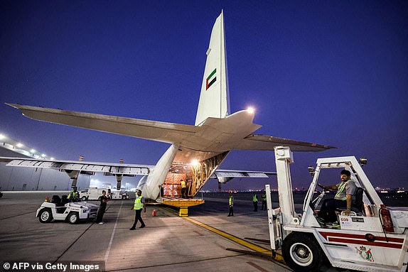 Humanitarian aid provided by the United Nations is loaded onto a United Arab Emirates Air Force C-130H-30 Hercules turboprop military transport aircraft at Dubai International Airport before departure for Cairo on October 19, 2023. Egypt announced on October 19 the 'sustainable' passage of humanitarian aid to the Gaza Strip through the Rafah crossing, as hundreds of aid trucks wait at the gates of the enclave being bombarded by Israel. (Photo by Giuseppe CACACE / AFP) (Photo by GIUSEPPE CACACE/AFP via Getty Images)