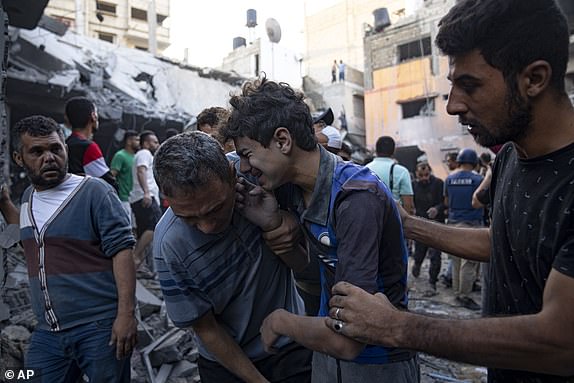 Palestinians react after an Israeli bombardment in Khan Younis, Gaza Strip, Thursday, Oct. 19, 2023. (AP Photo/Fatima Shbair)