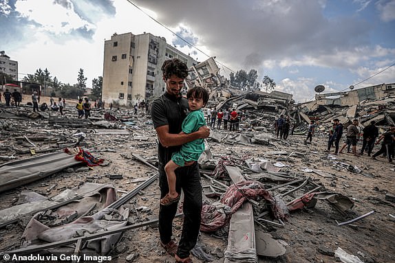 GAZA CITY, GAZA - OCTOBER 19: Palestinians are seen on the debris of destroyed buildings after Israeli airstrikes at al-Zahra neighborhood in Gaza Strip on October 19, 2023. (Photo by Ali Jadallah/Anadolu via Getty Images)