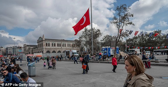 This photograph taken on October 19, 2023 in central Istanbul shows a Turkish flag raised at half-mast, after Turkey declared three days of national mourning over a deadly strike on a hospital in Gaza that killed hundreds. (Photo by BULENT KILIC / AFP) (Photo by BULENT KILIC/AFP via Getty Images)