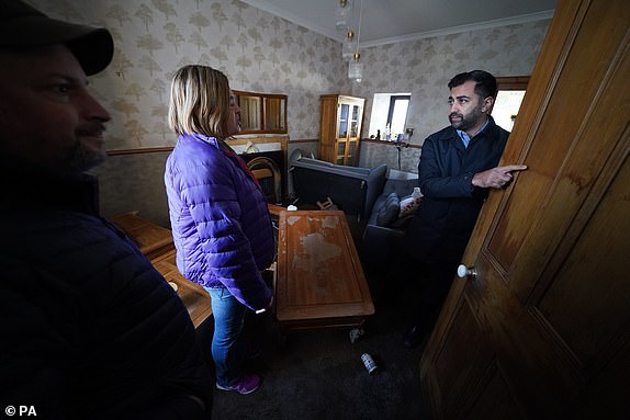 First Minister Humza Yousaf (right) speaks to Paul Fowlie and partner Kim Clark as he looks at water damage in their house during a visit to Brechin, Scotland, to thank members of the emergency services and Angus Council for their efforts in responding to the flooding caused by Storm Babet. Picture date: Monday October 23, 2023. PA Photo. See PA story WEATHER Babet. Picture credit should read: Andrew Milligan/PA Wire