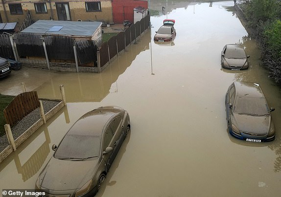 ROTHERHAM, UNITED KINGDOM - OCTOBER 23: In this aerial view, water damaged cars are seen as flood waters begin to recede in the village of Catcliffe after Storm Babet flooded homes, business and roads on October 23, 2023 in Rotherham, United Kingdom. The UK Environment Agency has warned that flooding could last for days in the wake of Storm Babet with 116 flood warnings remaining in place across England. (Photo by Christopher Furlong/Getty Images)