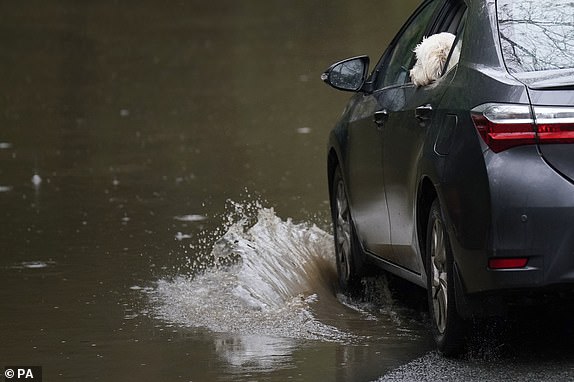 A car is driven through a flooded road in Faithlegg, Co. Waterford, Ireland, following Storm Babet, as warnings of heavy rainfall are in place across 20 counties, with forecasters urging people to be aware of flooding and dangerous road conditions on Monday. Picture date: Monday October 23, 2023. PA Photo. See PA story WEATHER Babet Ireland. Photo credit should read: Niall Carson/PA Wire