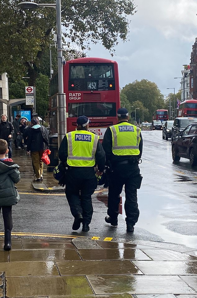 Officers patrolled central London streets holding riot helmets on Saturday