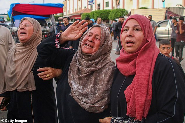 Family members of a young Palestinian man mourn after his death on October 22, 2023