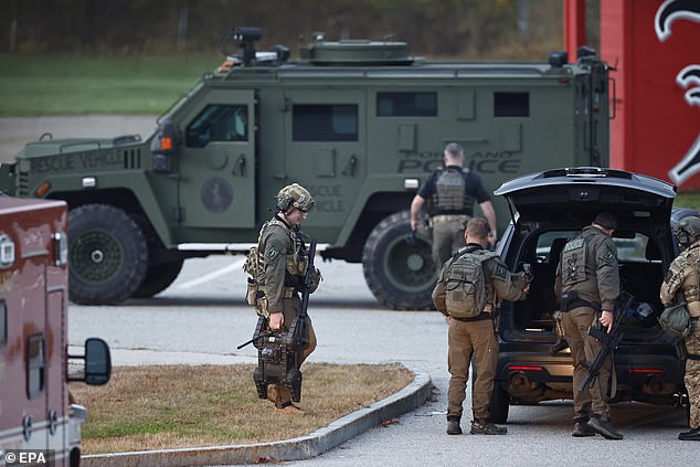 Tactical team members get ready to head back out to search for the suspect of a shooting in Lisbon