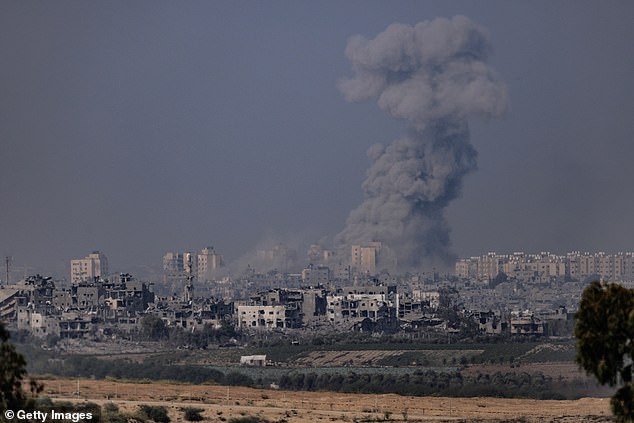 Smoke rises from an explosion in Gaza on Saturday. Israel says forces are 'still deployed out there and continuing their campaign'