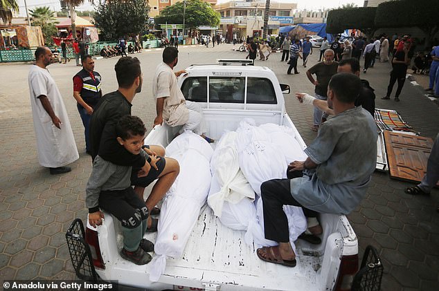 People take the bodies of their loved ones out of the mortuary at Al Aqsa Martyrs Hospital in Deir Al-Balah. The city is a short distance south of Gaza City in the northern part of the territory