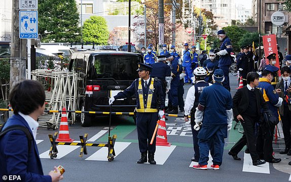 epa10977735 Japanese policemen investigate the scene after a driver crashed a car into a police barricade near the Israel Embassy, in Tokyo, Japan, 16 November 2023. Police arrested the driver of the car, a man in his 50's, who was lightly injured in the crash.  EPA/KIMIMASA MAYAMA