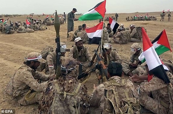 epa10951170 A handout photo made available by the Houthis media center shows Houthi fighters holding Palestinian and Yemenis flags during a military maneuver to express solidarity with the Palestinian people on the outskirts of Sana'a, Yemen, 29 October 2023 (Issued 31 October 2023). The Houthis announced on 31 October 2023 that they had launched ballistic missiles and drones towards Israel in support of the Palestinian people amid the ongoing conflict between Israel and Hamas. Thousands of Israelis and Palestinians have died since the militant group Hamas launched an unprecedented attack on Israel from the Gaza Strip on 07 October, and the Israeli strikes on the Palestinian enclave which followed it.  EPA/HOUTHIS MEDIA CENTER / HANDOUT EDITORIAL USE ONLY/NO SALES HANDOUT EDITORIAL USE ONLY/NO SALES HANDOUT EDITORIAL USE ONLY/NO SALES