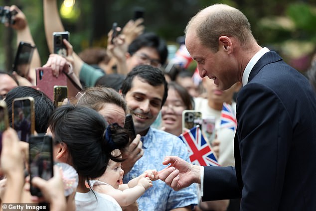 The Prince of Wales arrived at Changi Airport on Sunday to cheering crowds holding up signs, waving Union Jack flags and clutching photos of his late mother Princess Diana