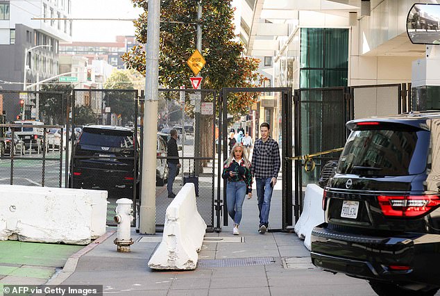People walk through a security gate as security preparations are under way
