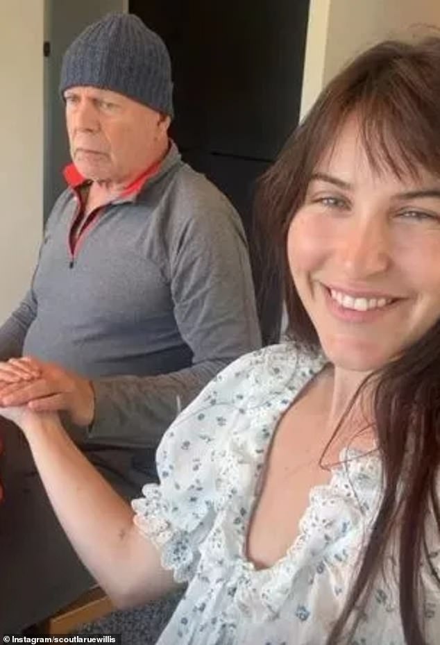 Happy: She wore a white, short-sleeved floral top with puff sleeves while Bruce opted for a long-sleeved sports shirt and a grey hat
