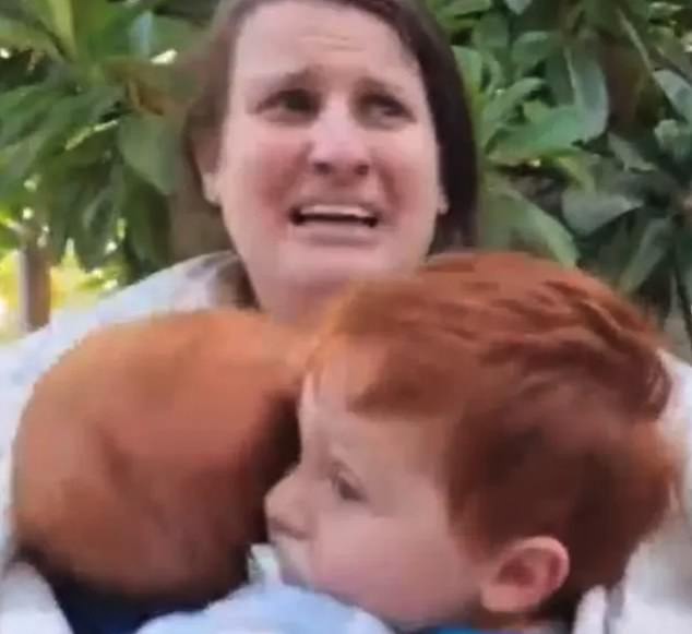 Video showed the sobbing mother clutching onto Kfir and Ariel as they were kidnapped, as horrified neighbours screamed: 'She has a baby.