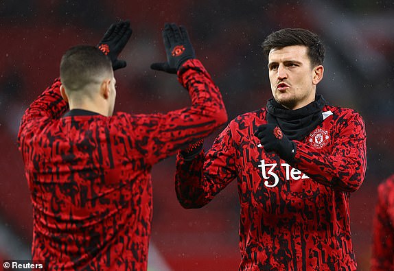 Soccer Football - Premier League - Manchester United v AFC Bournemouth - Old Trafford, Manchester, Britain - December 9, 2023 Manchester United's Harry Maguire and teammate during the warm up before the match REUTERS/Molly Darlington NO USE WITH UNAUTHORIZED AUDIO, VIDEO, DATA, FIXTURE LISTS, CLUB/LEAGUE LOGOS OR 'LIVE' SERVICES. ONLINE IN-MATCH USE LIMITED TO 45 IMAGES, NO VIDEO EMULATION. NO USE IN BETTING, GAMES OR SINGLE CLUB/LEAGUE/PLAYER PUBLICATIONS.