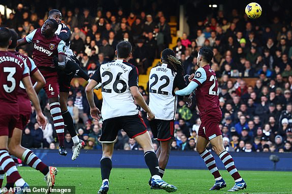 Fulham's English defender  #04 Tosin Adarabioyo (2L) heads home their third goal during the English Premier League football match between Fulham and West Ham United at Craven Cottage in London on December 10, 2023. (Photo by HENRY NICHOLLS / AFP) / RESTRICTED TO EDITORIAL USE. No use with unauthorized audio, video, data, fixture lists, club/league logos or 'live' services. Online in-match use limited to 120 images. An additional 40 images may be used in extra time. No video emulation. Social media in-match use limited to 120 images. An additional 40 images may be used in extra time. No use in betting publications, games or single club/league/player publications. /  (Photo by HENRY NICHOLLS/AFP via Getty Images)