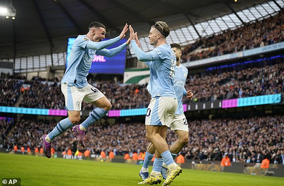 Manchester City's Jack Grealish, centre, celebrates after scoring his side's opening goal during the English Premier League soccer match between Manchester City and Crystal Palace at the Etihad Stadium in Manchester, England, Saturday, Dec.16, 2023. (AP Photo/Dave Thompson)