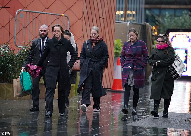 Brianna's mother Esther (middle) makes her way into the court during the first day of the trail on November 27