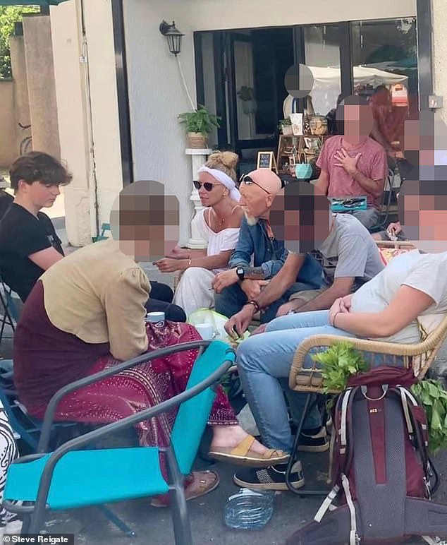 Melanie Batty sitting next to her father David Batty and her son Alex Batty (far left) at a market in June 2023