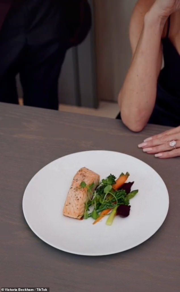 Hilarious: The Spice Girl, who has eaten the same meal for 25 years, sat at a table in front of a white cloche, before a waiter lifted it to reveal her usual fish and steamed vegetables