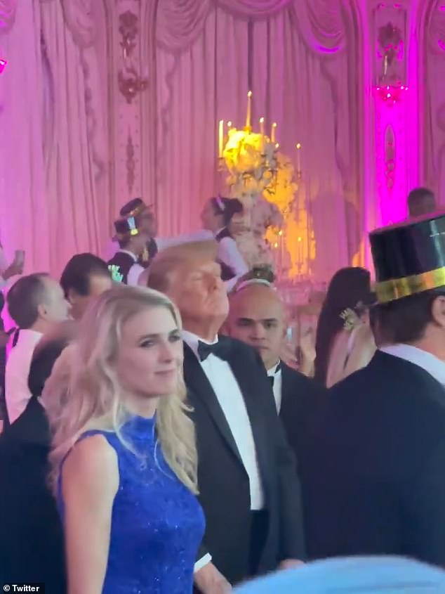 Trump's close aide Walt Nauta - who is also embroiled in the legal case regarding alleged mishandling of classified documents within Mar-a-Lago - was seen standing next to the former president enjoying the spectacle