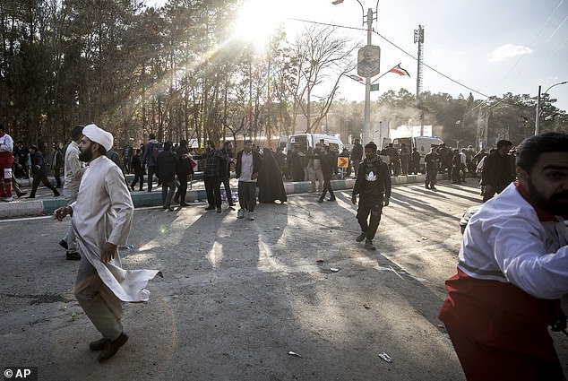 People are seen after an explosion in Kerman, Iran, on Wednesday