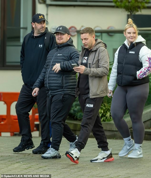 Littler steps out with his father (left), his manager, (centre) and his girlfriend (right) ahead of the big night
