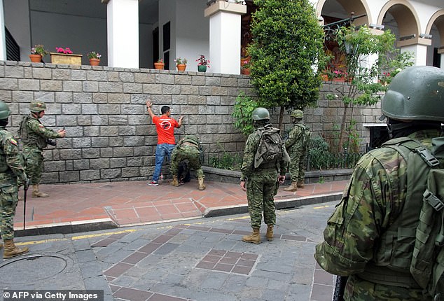 Ecuadorean soldiers search a man while on patrol in the streets of Cuenca, Ecuador, on Tuesday