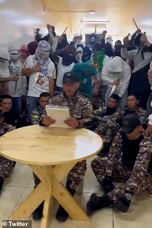 Terrifying footage shows gang members wielding machetes next to prison guards they are holding hostage