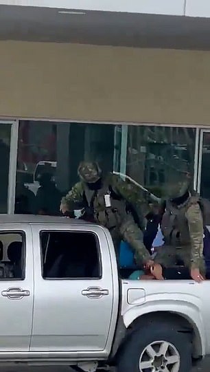 As the military carries out its orders to crack down on the violence in Ecuador, a clip (pictured) appeared to show an armed Ecuadorian soldier kicking a man, thought to be a suspected gangster, repeatedly in the head while in the back of a truck