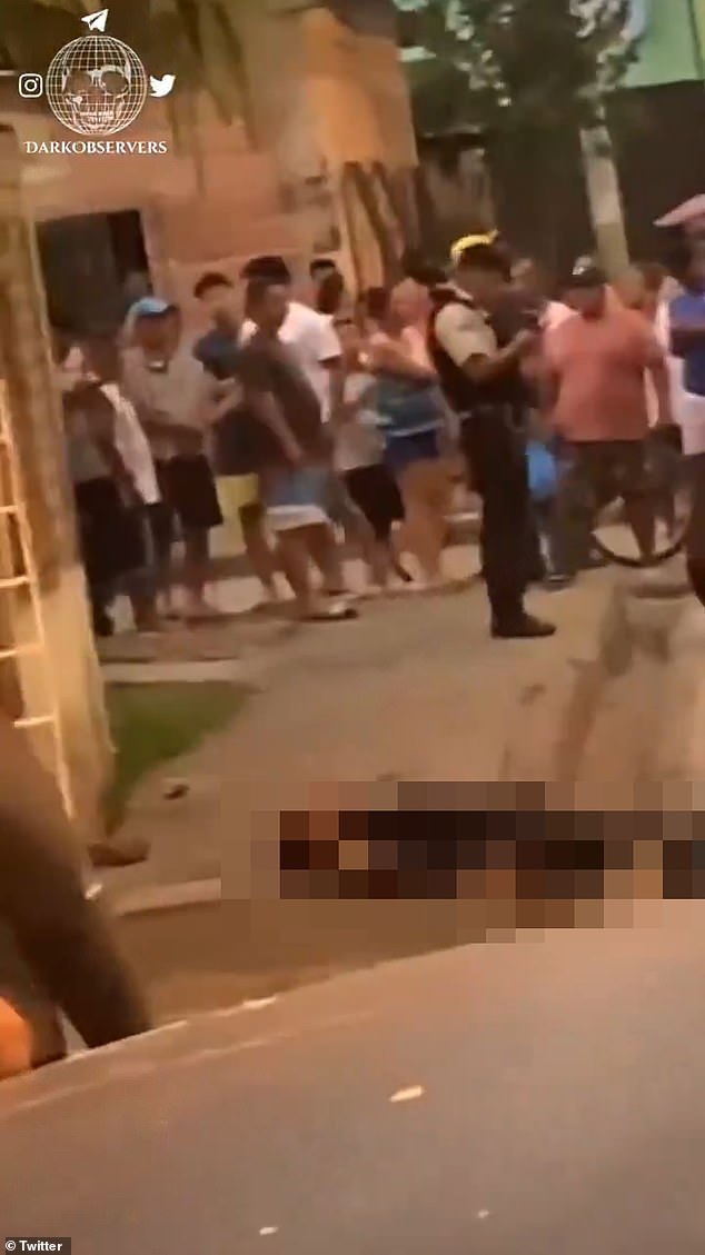 Another clips showed the body of a man, said to be a police officer, lying on the side of the road in a pool of blood. He appeared to have been shot in the head