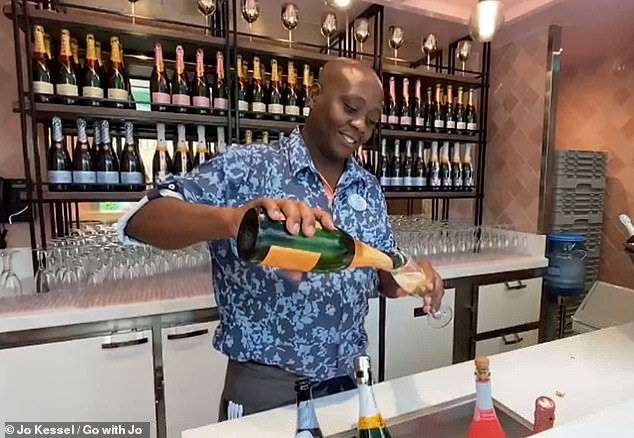 Here a barman at Bubbles pours Jo a glass of fizz