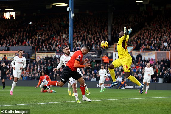 LUTON, ENGLAND - FEBRUARY 18: Carlton Morris of Luton Town scores his team's first goal past Andre Onana of Manchester United during the Premier League match between Luton Town and Manchester United at Kenilworth Road on February 18, 2024 in Luton, England. (Photo by Catherine Ivill/Getty Images)