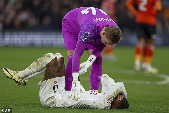 Manchester United's Marcus Rashford reacts after sustaining an injury during the English Premier League soccer match between Luton Town and Manchester United at Kenilworth Road, in Luton, England, Sunday, Feb. 18, 2024. (AP Photo/Ian Walton)