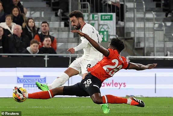 Soccer Football - Premier League - Luton Town v Manchester United - Kenilworth Road, Luton, Britain - February 18, 2024 Manchester United's Bruno Fernandes shoots at goal as Luton Town's Albert Sambi Lokonga blocks his shot REUTERS/Hannah Mckay NO USE WITH UNAUTHORIZED AUDIO, VIDEO, DATA, FIXTURE LISTS, CLUB/LEAGUE LOGOS OR 'LIVE' SERVICES. ONLINE IN-MATCH USE LIMITED TO 45 IMAGES, NO VIDEO EMULATION. NO USE IN BETTING, GAMES OR SINGLE CLUB/LEAGUE/PLAYER PUBLICATIONS.