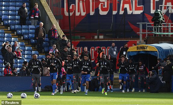 Soccer Football - Premier League - Crystal Palace v Burnley - Selhurst Park, London, Britain - February 24, 2024 Crystal Palace's Jordan Ayew and James Tomkins with teammates during the warm up before the match REUTERS/Isabel Infantes NO USE WITH UNAUTHORIZED AUDIO, VIDEO, DATA, FIXTURE LISTS, CLUB/LEAGUE LOGOS OR 'LIVE' SERVICES. ONLINE IN-MATCH USE LIMITED TO 45 IMAGES, NO VIDEO EMULATION. NO USE IN BETTING, GAMES OR SINGLE CLUB/LEAGUE/PLAYER PUBLICATIONS.