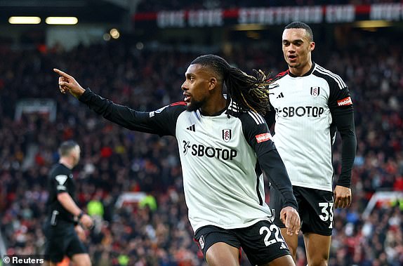 Soccer Football - Premier League - Manchester United v Fulham - Old Trafford, Manchester, Britain - February 24, 2024 Fulham's Alex Iwobi celebrates scoring their second goal with Antonee Robinson REUTERS/Carl Recine NO USE WITH UNAUTHORIZED AUDIO, VIDEO, DATA, FIXTURE LISTS, CLUB/LEAGUE LOGOS OR 'LIVE' SERVICES. ONLINE IN-MATCH USE LIMITED TO 45 IMAGES, NO VIDEO EMULATION. NO USE IN BETTING, GAMES OR SINGLE CLUB/LEAGUE/PLAYER PUBLICATIONS.